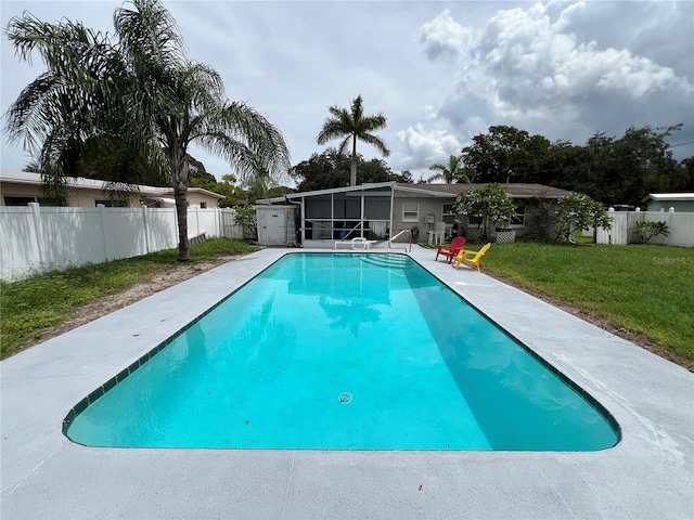 view of swimming pool with a sunroom and a lawn