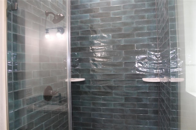 bathroom with a shower with door