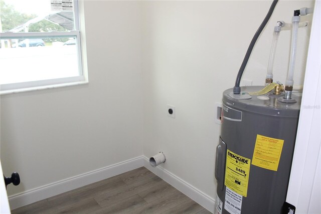 clothes washing area featuring water heater, washer hookup, electric dryer hookup, and hardwood / wood-style flooring