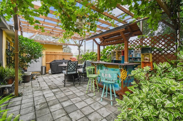 view of patio featuring a pergola and exterior bar