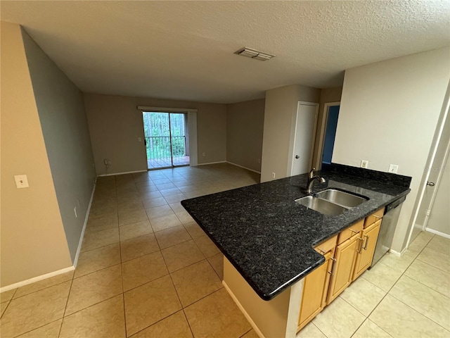 kitchen featuring light tile patterned floors, a textured ceiling, sink, and stainless steel dishwasher