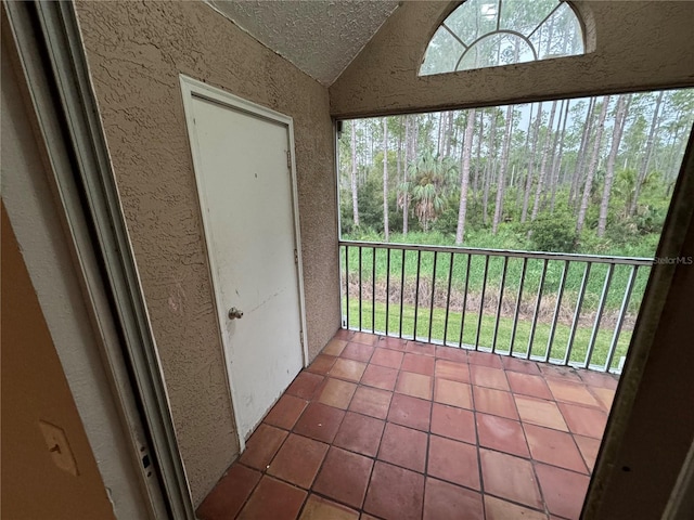 unfurnished sunroom featuring lofted ceiling