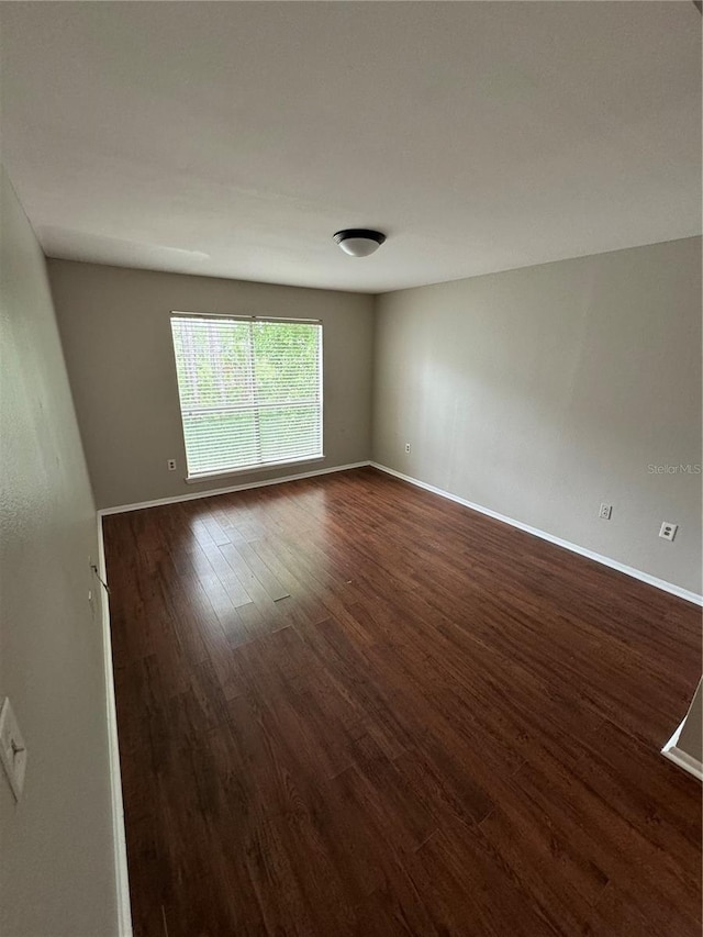 empty room featuring dark wood-type flooring