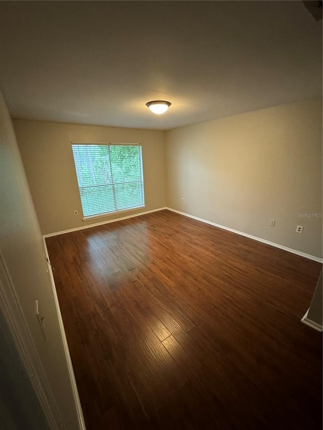 empty room featuring dark hardwood / wood-style flooring