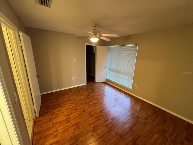 unfurnished bedroom featuring ceiling fan, hardwood / wood-style flooring, and a closet