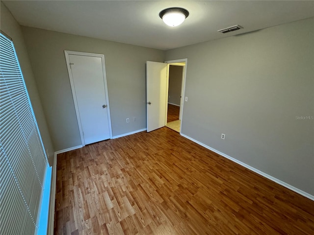 unfurnished bedroom with light hardwood / wood-style floors and a closet