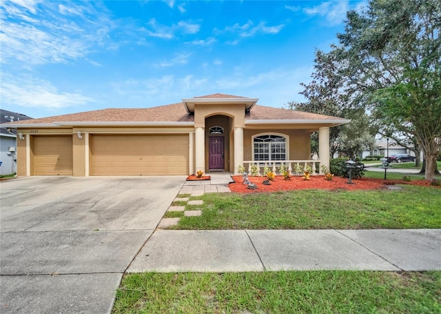 view of front of property with a front lawn and a garage