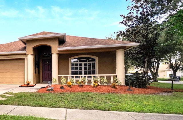 view of front of property with a garage and a front lawn