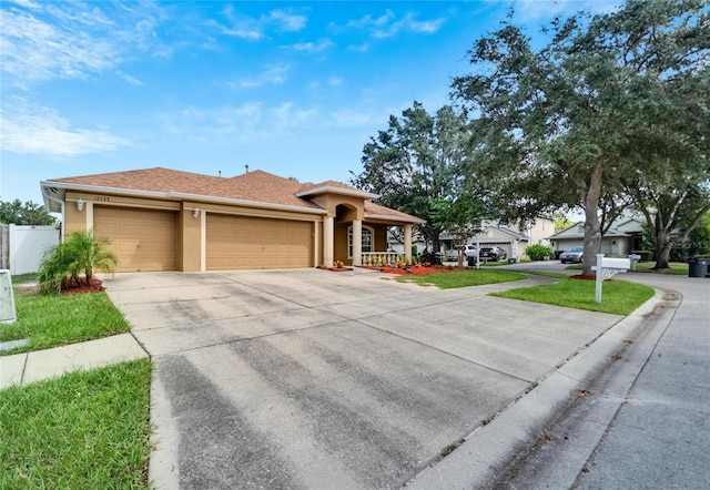 12739 Standbridge Dr, Riverview, FL 33579 - view of front of property featuring a garage, concrete driveway, and stucco siding