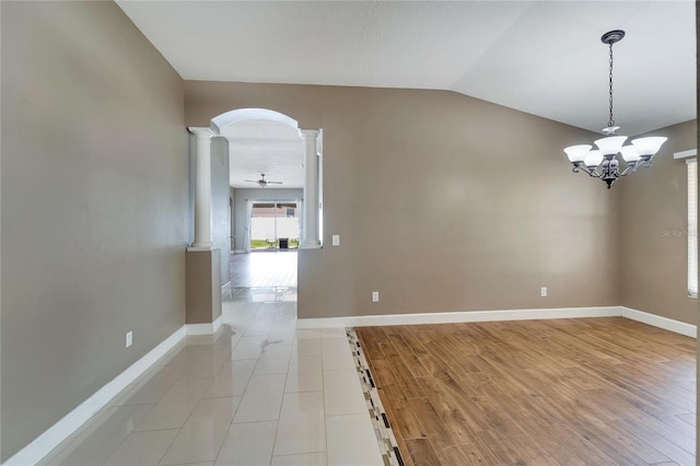 12739 Standbridge Dr, Riverview, FL 33579 - unfurnished room featuring ornate columns, lofted ceiling, arched walkways, a chandelier, and baseboards