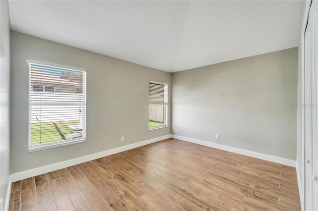 unfurnished room featuring light hardwood / wood-style flooring and a healthy amount of sunlight