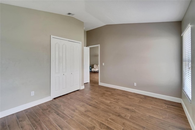 12739 Standbridge Dr, Riverview, FL 33579 - unfurnished bedroom with wood finished floors, lofted ceiling, baseboards, and a closet