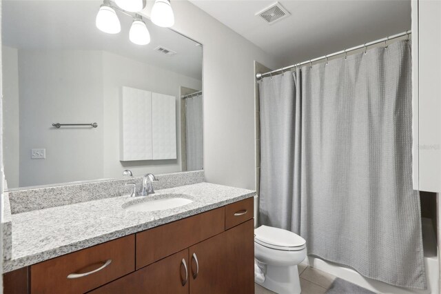 bathroom with vanity, toilet, a shower with shower curtain, and tile patterned floors