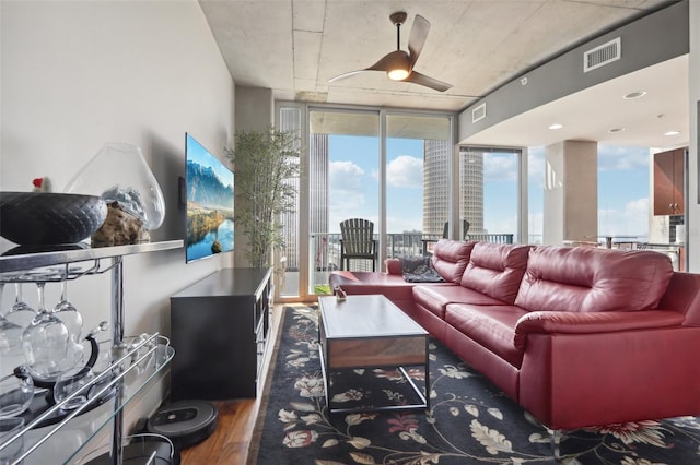 living room featuring ceiling fan, dark hardwood / wood-style floors, and expansive windows