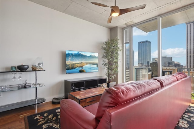 living room with floor to ceiling windows, ceiling fan, and dark wood-type flooring