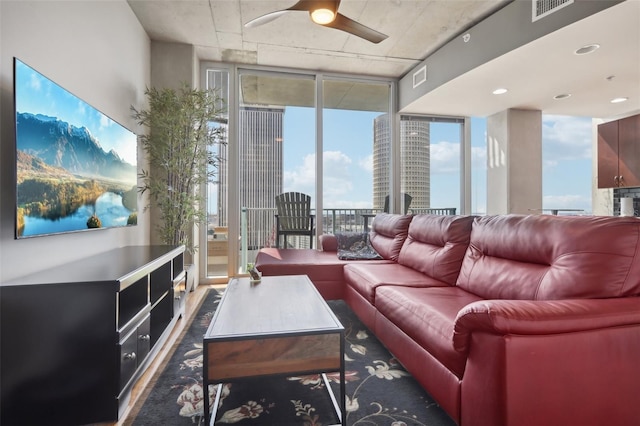 living room featuring floor to ceiling windows and ceiling fan