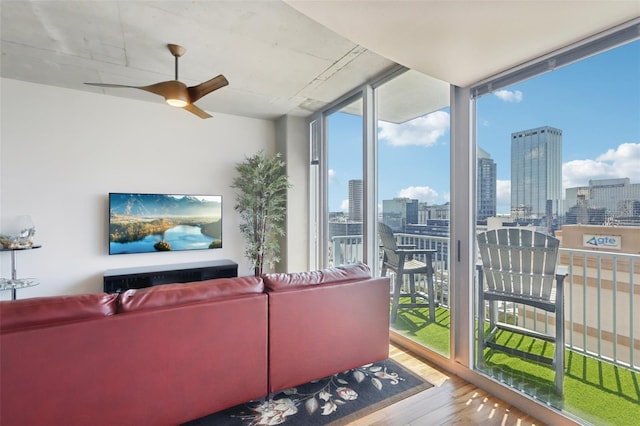 living room featuring ceiling fan, floor to ceiling windows, and hardwood / wood-style floors