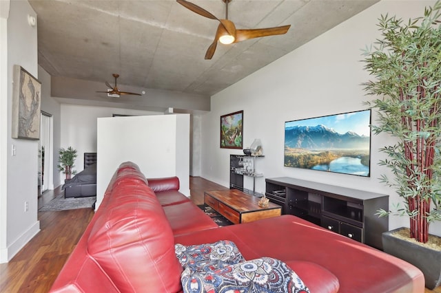 living room featuring ceiling fan and dark hardwood / wood-style floors