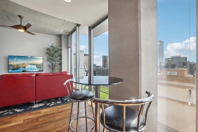 777 N Ashley Dr Unit 1606, Tampa, FL 33602 - dining area featuring a skyline view, wood finished floors, healthy amount of natural light, and a ceiling fan