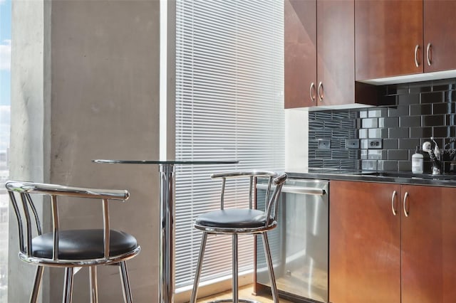 bar with backsplash, stainless steel dishwasher, and sink