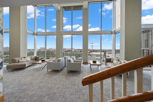 777 N Ashley Dr Unit 1606, Tampa, FL 33602 - living area with carpet flooring, a towering ceiling, expansive windows, healthy amount of natural light, and a view of city