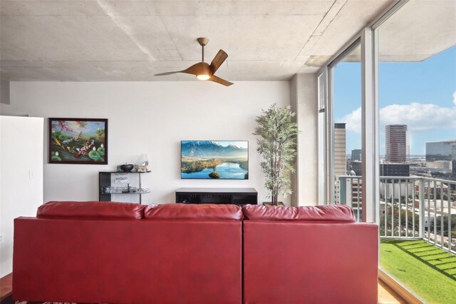 living room with a healthy amount of sunlight, ceiling fan, and expansive windows