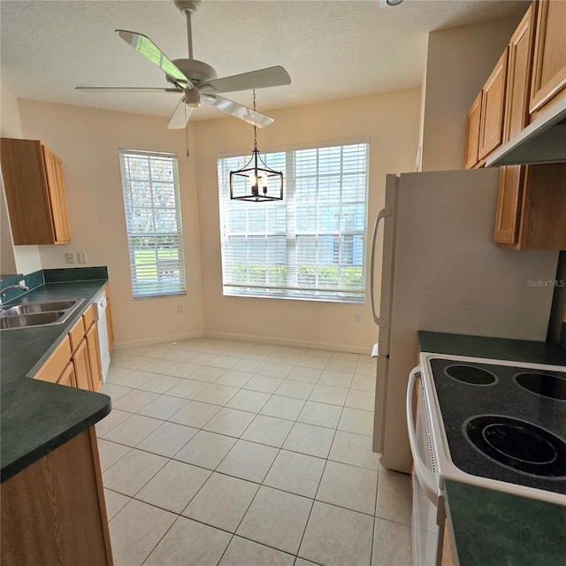 kitchen with sink, ceiling fan with notable chandelier, electric stove, a textured ceiling, and light tile patterned floors