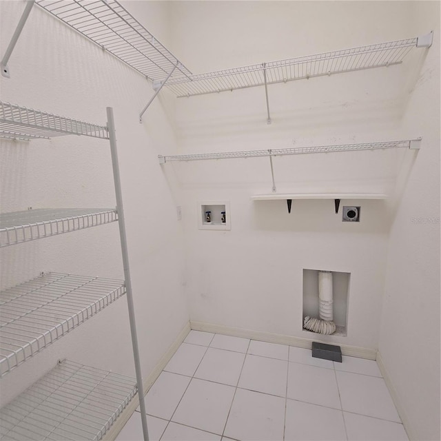 laundry area with hookup for a washing machine, light tile patterned flooring, and electric dryer hookup