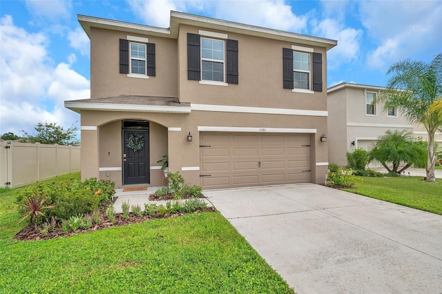 view of front of house with a front yard and a garage