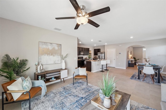 tiled living room with ceiling fan