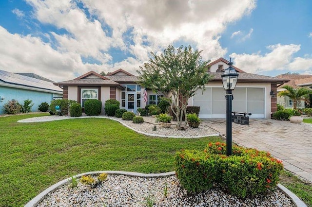 single story home with a garage and a front lawn