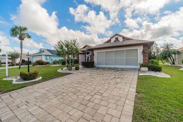 ranch-style home featuring a garage and a front lawn