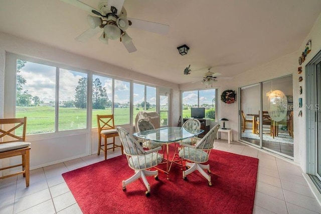 sunroom / solarium featuring ceiling fan