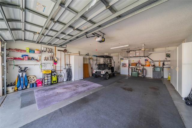 garage with white refrigerator and a garage door opener