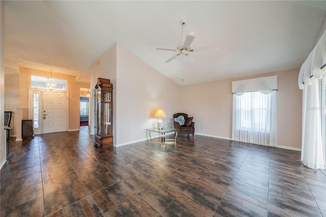 unfurnished living room with ceiling fan and lofted ceiling