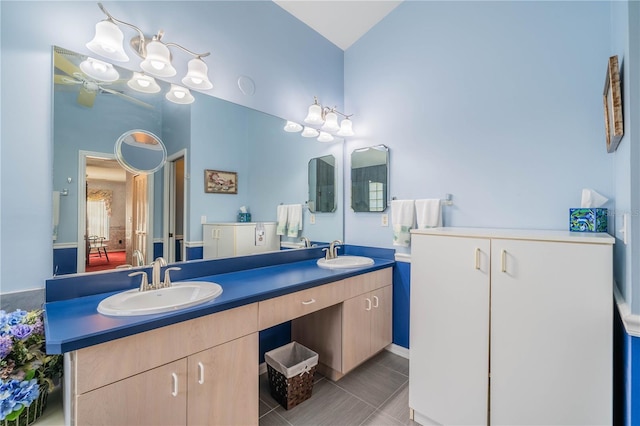 bathroom with vanity, a notable chandelier, and tile patterned flooring