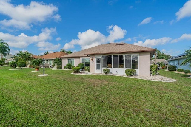 rear view of house featuring a yard