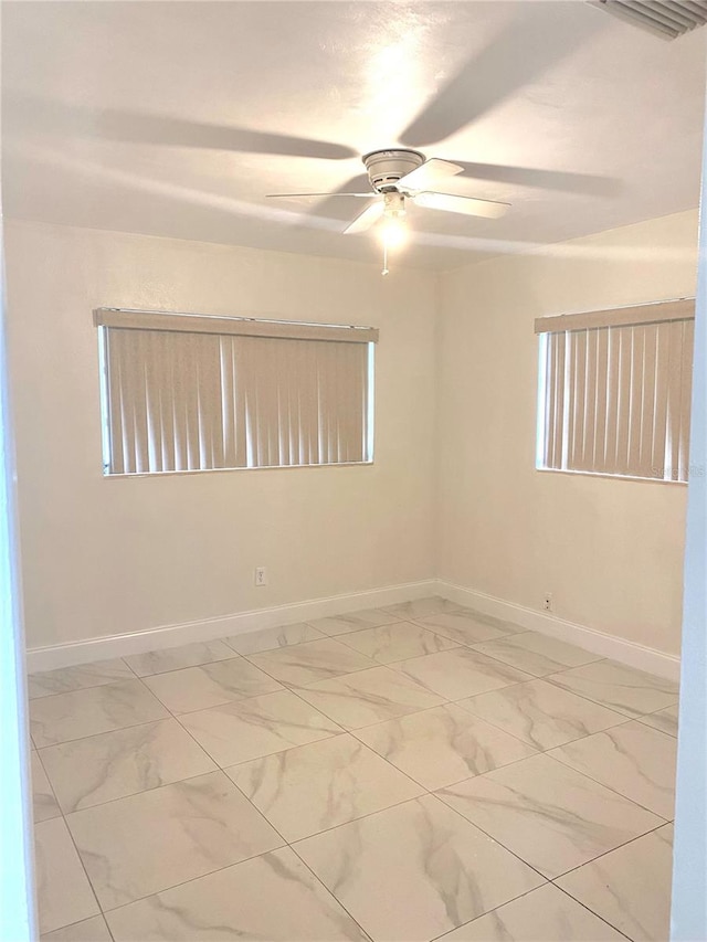 spare room with ceiling fan