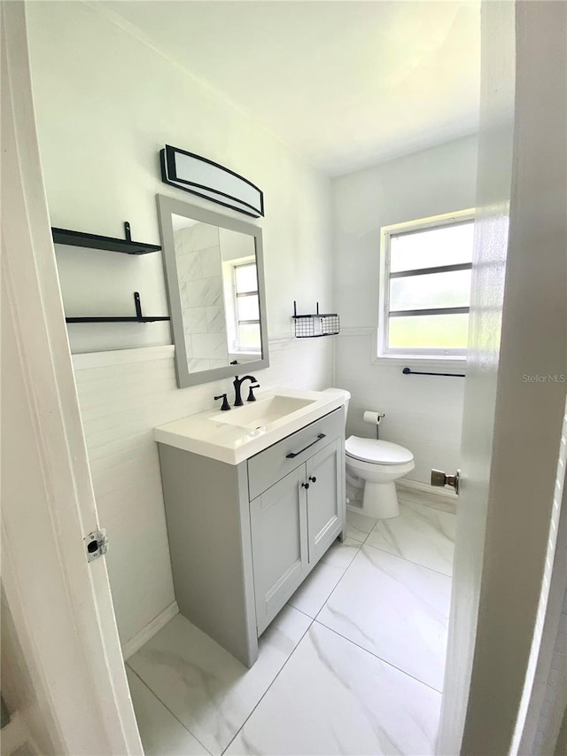 bathroom featuring vanity and toilet