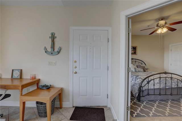 interior space featuring light tile patterned flooring and ceiling fan