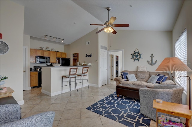 living room featuring light tile patterned floors, high vaulted ceiling, ceiling fan, and track lighting