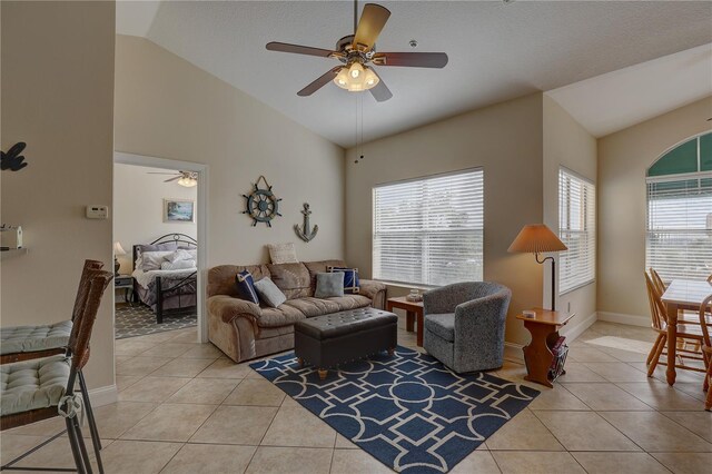 tiled living room with a textured ceiling, vaulted ceiling, and ceiling fan