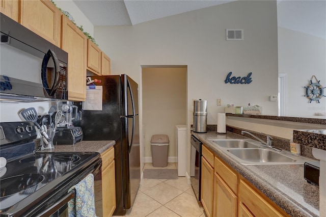 kitchen featuring light tile patterned flooring, vaulted ceiling, light brown cabinets, black appliances, and sink