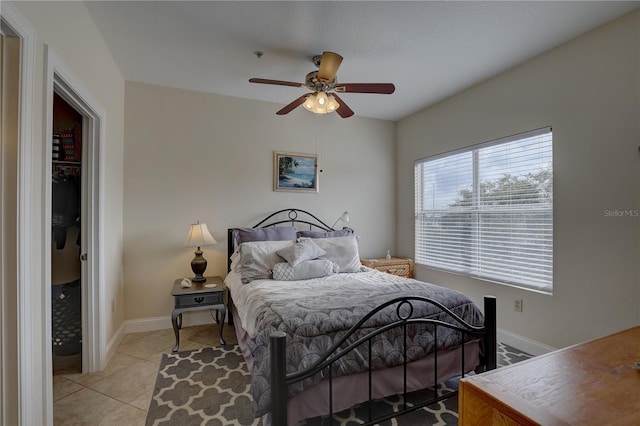 tiled bedroom with ceiling fan