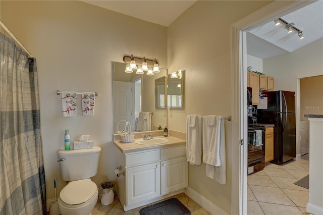 bathroom with vanity, tile patterned flooring, toilet, and a textured ceiling