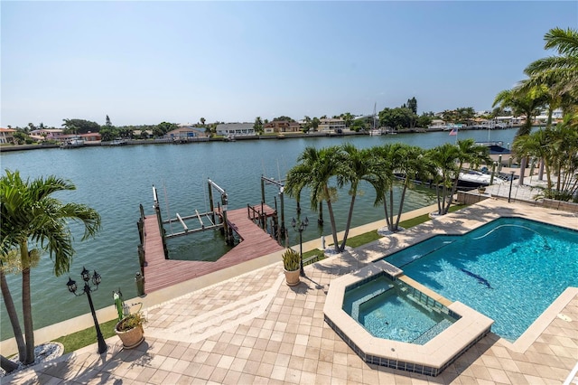 view of pool featuring a water view, an in ground hot tub, a patio, and a boat dock