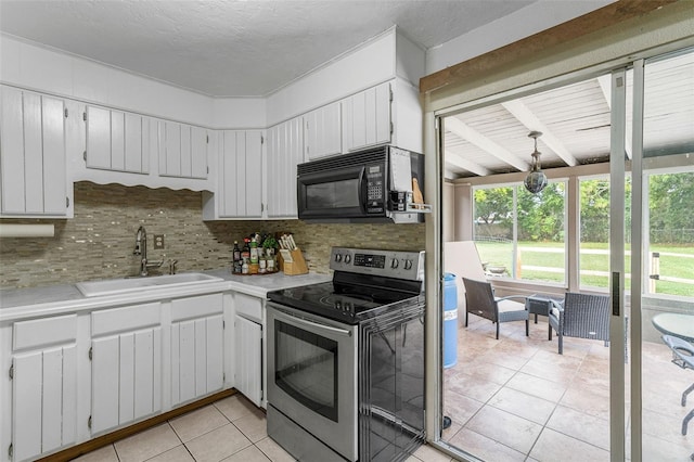 kitchen featuring stainless steel range with electric stovetop, white cabinets, and sink