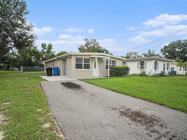 ranch-style home with a front lawn