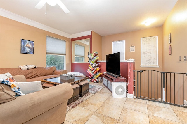 living room with light tile patterned flooring, ornamental molding, and ceiling fan