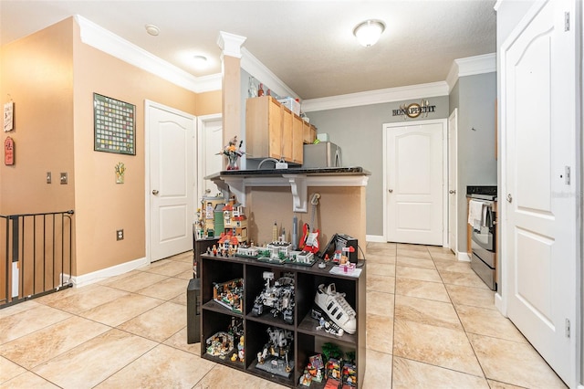 kitchen featuring light tile patterned flooring, ornamental molding, and stainless steel range oven